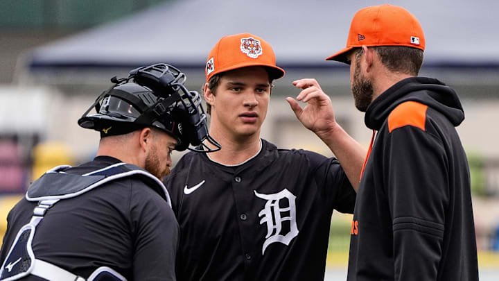 Detroit Tigers pitcher Jackson Jobe, center, talks to j, left, and pitching coach Chris Fetter during spring training at Joker Marchant Stadium in Lakeland, Fla. on Thursday, Feb. 20, 2025.