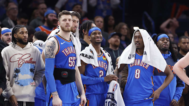 Feb 10, 2025; Oklahoma City, Oklahoma, USA; Oklahoma City Thunder guard Isaiah Joe (11), center Isaiah Hartenstein (55), forward Chet Holmgren (7), guard Shai Gilgeous-Alexander (2), forward Jalen Williams (8) and guard Luguentz Dort (5) watch the end of a game against the New Orleans Pelicans at Paycom Center. Mandatory Credit: Alonzo Adams-Imagn Images
