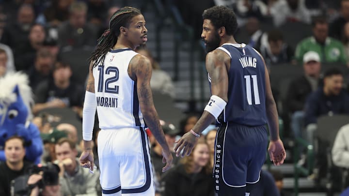 Dec 3, 2024; Dallas, Texas, USA;  Memphis Grizzlies guard Ja Morant (12) and Dallas Mavericks guard Kyrie Irving (11) chat during the first quarter at American Airlines Center. Mandatory Credit: Kevin Jairaj-Imagn Images