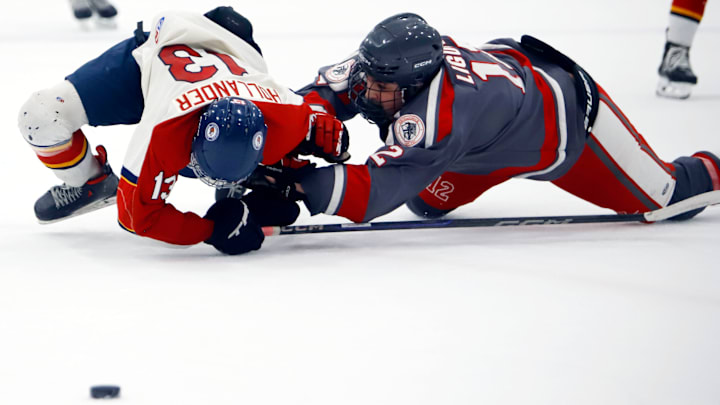 Neshannock's Brady Liguore hauls down Morgantown (W.Va.) forward Jacob Hollander during the second period during a varsity Division 2 Penguins Cup semifinal Thursday night at the RMU Island Sports Center.