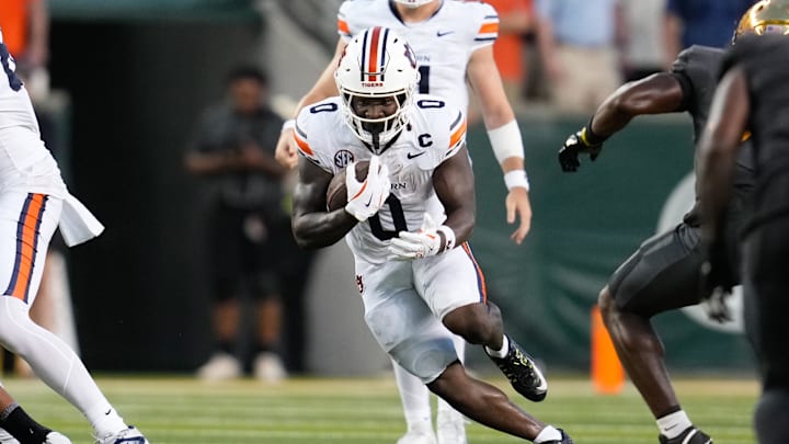 Aug 29, 2025; Waco, Texas, USA;  Auburn Tigers running back Damari Alston (0) runs the ball against the Baylor Bears during the first half at McLane Stadium. Mandatory Credit: Chris Jones-Imagn Images