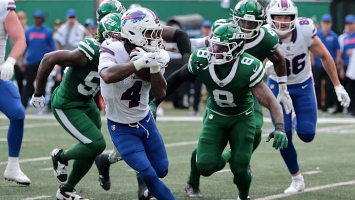 Sep 14, 2025; East Rutherford, New Jersey, USA; Buffalo Bills running back James Cook (4) rushes the ball past New York Jets safety Andre Cisco (8)