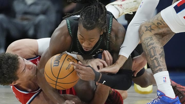 Feb 8, 2026; Minneapolis, Minnesota, USA; Minnesota Timberwolves guard Ayo Dosunmu (13) battles Los Angeles Clippers center Brook Lopez (11) for the ball in the first quarter at Target Center.