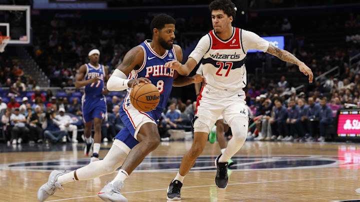 Apr 1, 2026; Washington, District of Columbia, USA; Philadelphia 76ers forward Paul George (8) drives to the basket as Washington Wizards guard Will Riley (27) defends in the first half at Capital One Arena. Mandatory Credit: Geoff Burke-Imagn Images