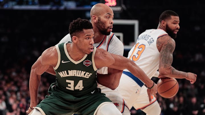 Dec 21, 2019; New York, New York, USA; Milwaukee Bucks forward Giannis Antetokounmpo (34) fights for position against New York Knicks forward Taj Gibson (67) as Marcus Morris Sr. (13) dribbles the ball during the first quarter at Madison Square Garden. Mandatory Credit: Vincent Carchietta-Imagn Images