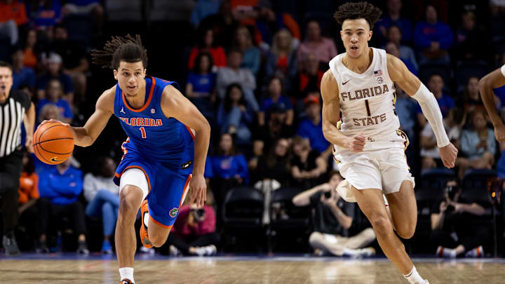 Nov 17, 2023; Gainesville, Florida, USA; Florida Gators guard Walter Clayton Jr. (1) dribbles the ball past Florida State Seminoles guard Jalen Warley (1) during the second half at Exactech Arena at the Stephen C. O'Connell Center. Mandatory Credit: Matt Pendleton-Imagn Images Nov 17, 2023; Gainesville, Florida, USA; Florida Gators guard Walter Clayton Jr. (1) dribbles the ball past Florida State Seminoles guard Jalen Warley (1) during the second half at Exactech Arena at the Stephen C. O'Connell Center. Mandatory Credit: Matt Pendleton-Imagn Images