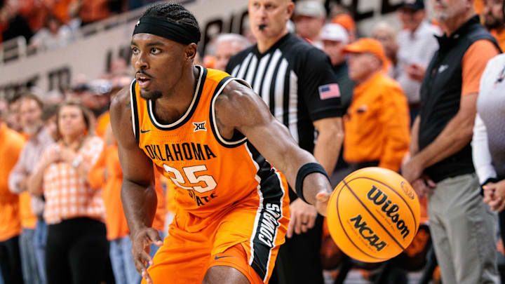 Nov 9, 2025; Stillwater, Oklahoma, USA; Oklahoma State Cowboys forward Robert Jennings II passes the ball during the first half against the Texas A&M Aggies at Gallagher-Iba Arena.