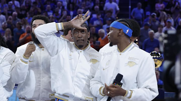 Oct 21, 2025; Oklahoma City, Oklahoma, USA; Oklahoma City Thunder guard Jalen Williams (8) gestures while Oklahoma City Thunder guard Shai Gilgeous-Alexander (2) looks at him during the NBA Championship ring ceremony at Paycom Center. Mandatory Credit: Alonzo Adams-Imagn Images