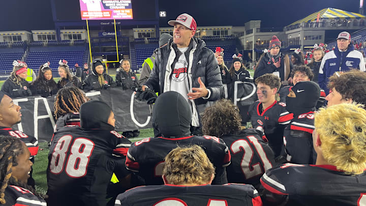 Quince Orchard head football coach John Kelley addresses his team after its victory in the 2024 MPSSAA 4A state championship game.