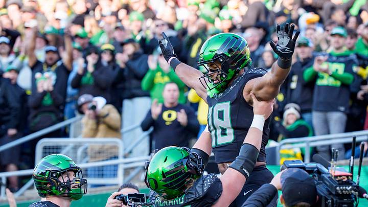 Oregon offensive lineman Charlie Pickard hoists tight end Kenyon Sadiq into the air to celebrate a touchdown as the Oregon Ducks host the USC Trojans on Nov. 22, 2025, at Autzen Stadium in Eugene, Oregon.