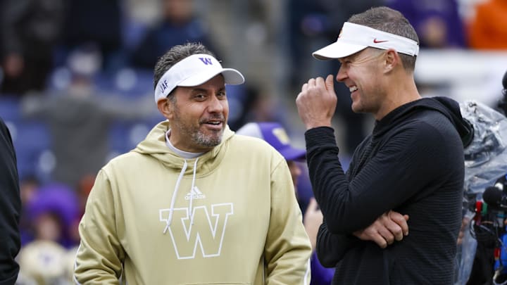 Nov 2, 2024; Seattle, Washington, USA; Washington Huskies head coach Jedd Fisch, left, talks with USC Trojans head coach Lincoln Riley during pregame warmups at Alaska Airlines Field at Husky Stadium. Nov 2, 2024; Seattle, Washington, USA; Washington Huskies head coach Jedd Fisch, left, talks with USC Trojans head coach Lincoln Riley during pregame warmups at Alaska Airlines Field at Husky Stadium.