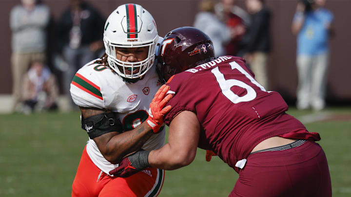 Oct 15, 2022; Blacksburg, Virginia, USA;  Virginia Tech Hokies offensive lineman Braelin Moore (61) blocks Miami Hurricanes defensive lineman Akheem Mesidor (90) during the second half at Lane Stadium. Mandatory Credit: Reinhold Matay-Imagn Images