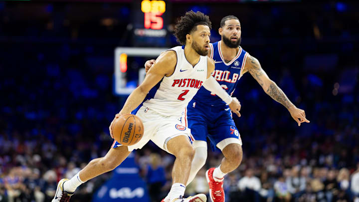 Oct 30, 2024; Philadelphia, Pennsylvania, USA; Detroit Pistons guard Cade Cunningham (2) dribbles the ball in front of Philadelphia 76ers forward Caleb Martin (16) during the first quarter at Wells Fargo Center. Mandatory Credit: Bill Streicher-Imagn Images