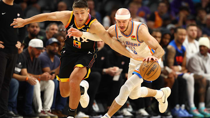 Apr 9, 2025; Phoenix, Arizona, USA; Oklahoma City Thunder guard Alex Caruso (9) and Phoenix Suns guard Grayson Allen (8) attempt to get a ball during the second half at Footprint Center. Mandatory Credit: Mark J. Rebilas-Imagn Images