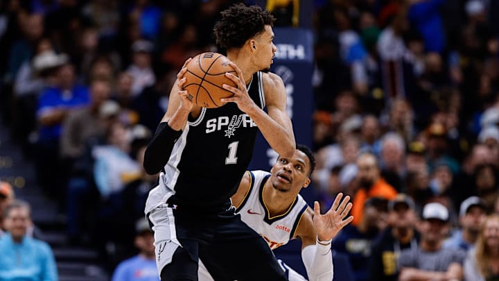 Jan 3, 2025; Denver, Colorado, USA; San Antonio Spurs center Victor Wembanyama (1) controls the ball as Denver Nuggets guard Russell Westbrook (4) guards in the third quarter at Ball Arena.