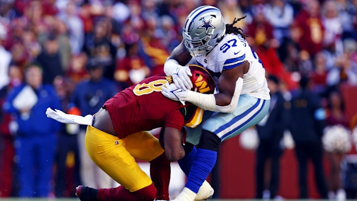 Washington Commanders running back Brian Robinson Jr. is tackled by Dallas Cowboys defensive tackle Osa Odighizuwa. Washington Commanders running back Brian Robinson Jr. is tackled by Dallas Cowboys defensive tackle Osa Odighizuwa.