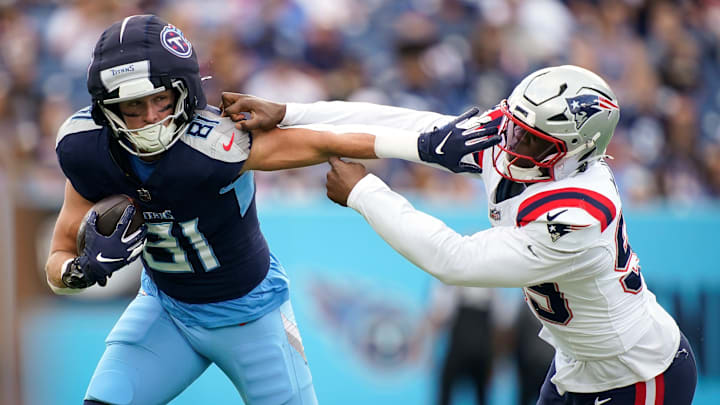 Tennessee Titans tight end Josh Whyle (81) stiff arms New England Patriots defensive end Keion White (99) bringing in a first down during the first quarter at Nissan Stadium in Nashville, Tenn., Sunday, Nov. 3, 2024.