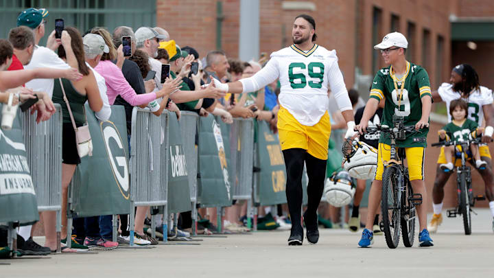 Green Bay Packers' offensive tackle David Bakhtiari (69) high fives fans during the first day of