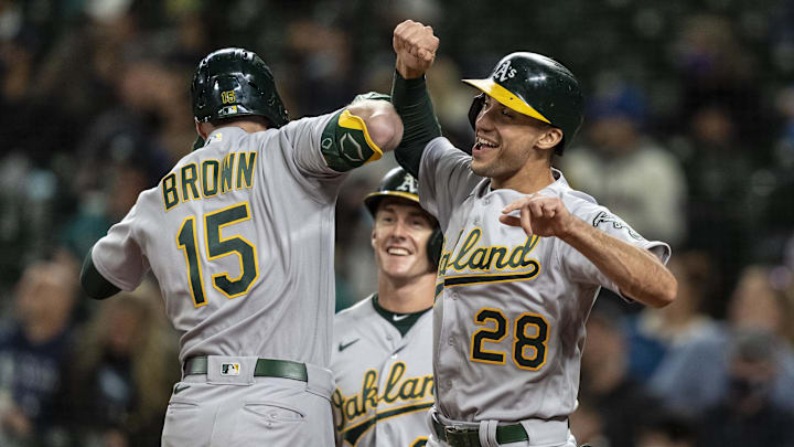 Sep 27, 2021; Seattle, Washington, USA;  Oakland Athletics centerfielder Seth Brown (15) celebrates with first baseman Matt Olson (28) and left fielder Mark Canha (20) after hitting a three run home run against the Seattle Mariners during the first inning at T-Mobile Park. Mandatory Credit: Stephen Brashear-Imagn Images