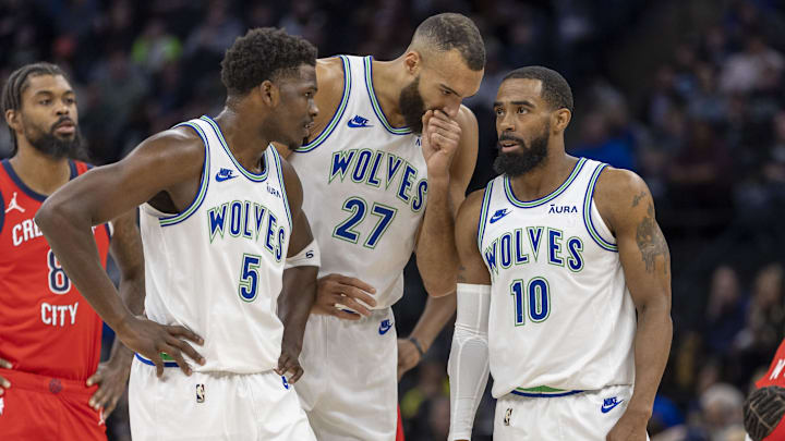 Minnesota Timberwolves guards Anthony Edwards (5) and Mike Conley (10) and center Rudy Gobert talk during a free throw against the New Orleans Pelicans in the first half at Target Center in Minneapolis on Jan. 3, 2024.