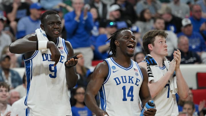 Mar 21, 2025; Raleigh, NC, USA; Duke Blue Devils center Khaman Maluach (9), guard Sion James (14) and guard Kon Knueppel (7) celebrate from the bench during the second half against the Mount St. Mary's Mountaineers in the first round of the NCAA Tournament at Lenovo Center. Mandatory Credit: Zachary Taft-Imagn Images Mar 21, 2025; Raleigh, NC, USA; Duke Blue Devils center Khaman Maluach (9), guard Sion James (14) and guard Kon Knueppel (7) celebrate from the bench during the second half against the Mount St. Mary's Mountaineers in the first round of the NCAA Tournament at Lenovo Center. Mandatory Credit: Zachary Taft-Imagn Images