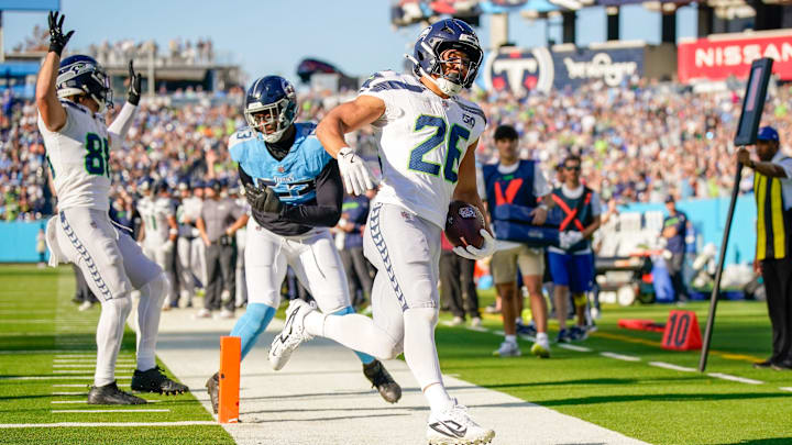 Seattle Seahawks running back Zach Charbonnet (26) scores a touchdown past Tennessee Titans linebacker Jihad Ward (53) during the third quarter at Nissan Stadium in Nashville, Tenn., Sunday, Nov. 23, 2025.