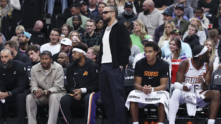 Oct 27, 2025; Salt Lake City, Utah, USA; Phoenix Suns forward Dillon Brooks, center, watches play from the bench wearing street clothes during the second half of a game against the Utah Jazz at Delta Center. Mandatory Credit: Rob Gray-Imagn Images
