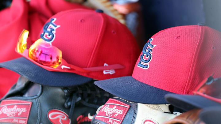 Mar 6, 2019; Tampa, FL, USA; St. Louis Cardinals hat and gloves lay in the dugout at George M. Steinbrenner Field. Mandatory Credit: Kim Klement-Imagn Images