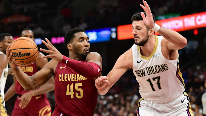 Nov 20, 2024; Cleveland, Ohio, USA; Cleveland Cavaliers guard Donovan Mitchell (45) drives to the basket against New Orleans Pelicans center Karlo Matkovic (17) during the first half at Rocket Mortgage FieldHouse. Mandatory Credit: Ken Blaze-Imagn Images