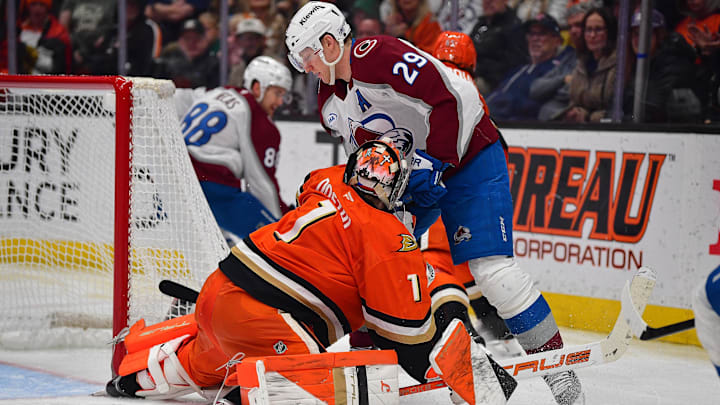 Mar 3, 2026; Anaheim, California, USA; Colorado Avalanche center Nathan MacKinnon (29) collides with Anaheim Ducks goaltender Lukas Dostal (1) during the third period at Honda Center. Mandatory Credit: Gary A. Vasquez-Imagn Images