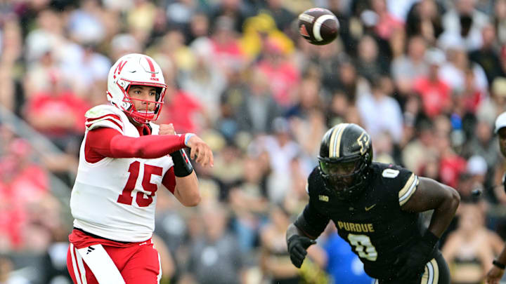 Sep 28, 2024; West Lafayette, Indiana, USA; Nebraska Cornhuskers quarterback Dylan Raiola (15) throws a pass under pressure from Purdue Boilermakers defensive lineman Jeffrey M'Ba (0) during the second quarter at Ross-Ade Stadium.