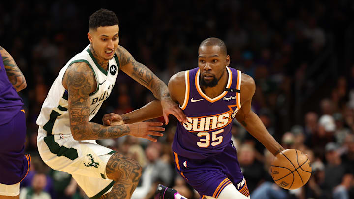 Mar 24, 2025; Phoenix, Arizona, USA; Milwaukee Bucks forward Kyle Kuzma (18) against Phoenix Suns forward Kevin Durant (35) at Footprint Center. Mandatory Credit: Mark J. Rebilas-Imagn Images