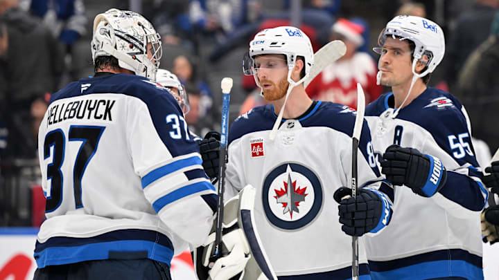 Dec 23, 2024; Toronto, Ontario, CAN; Winnipeg Jets goalie Connor Hellebuyck (37) is joined by forwards Kyle Connor (81) and Mark Scheifele (55) as they celebrate a win over the Toronto Maple Leaf at Scotiabank Arena. Mandatory Credit: Dan Hamilton-Imagn Images Dec 23, 2024; Toronto, Ontario, CAN; Winnipeg Jets goalie Connor Hellebuyck (37) is joined by forwards Kyle Connor (81) and Mark Scheifele (55) as they celebrate a win over the Toronto Maple Leaf at Scotiabank Arena. Mandatory Credit: Dan Hamilton-Imagn Images