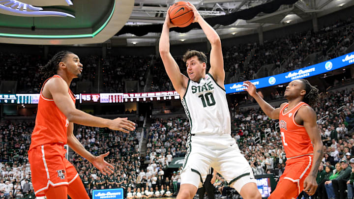 Nov 16, 2024; East Lansing, Michigan, USA;  Michigan State Spartans center Szymon Zapala (10) keeps a rebound away from Bowling Green Falcons forward Sam Towns (14) and guard Javontae Campbell (2) during the second half at Jack Breslin Student Events Center. Mandatory Credit: Dale Young-Imagn Images