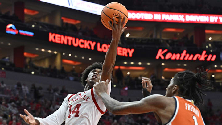 Mar 3, 2026; Louisville, Kentucky, USA;  Louisville Cardinals guard Adrian Wooley (14) shoots against Syracuse Orange forward Donnie Freeman (1) during the first half at KFC Yum! Center. Mandatory Credit: Jamie Rhodes-Imagn Images