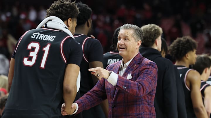 Jan 14, 2026; Fayetteville, Arkansas, USA; Arkansas Razorbacks head coach John Calipari shakes hands with South Carolina Gamecocks forward Elijah Strong (31) after the game at Bud Walton Arena. Arkansas won 108-74. Mandatory Credit: Nelson Chenault-Imagn Images