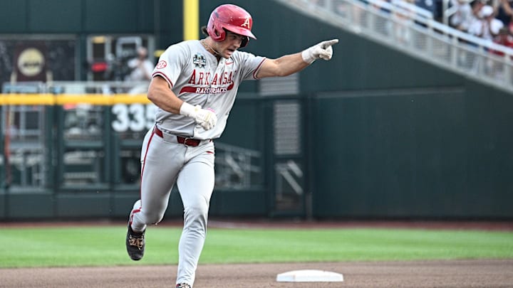 Jun 18, 2025; Omaha, Neb, USA;  Arkansas Razorbacks catcher Ryder Helfrick (27) points as he circles the bases after hitting a home run against the LSU Tigers during the fourth inning at Charles Schwab Field. Mandatory Credit: Steven Branscombe-Imagn Images