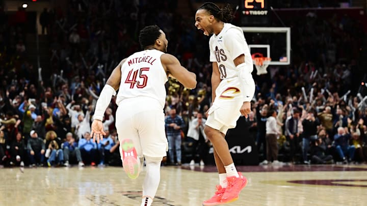 Jan 8, 2025; Cleveland, Ohio, USA; Cleveland Cavaliers guard Donovan Mitchell (45) and guard Darius Garland (10) celebrate after Mitchell made a three point basket during the second half against the Oklahoma City Thunder at Rocket Mortgage FieldHouse. Mandatory Credit: Ken Blaze-Imagn Images
