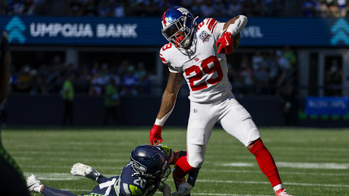 Oct 6, 2024; Seattle, Washington, USA; New York Giants running back Tyrone Tracy Jr. (29) breaks a tackle attempt by Seattle Seahawks safety Julian Love (20) during the second quarter at Lumen Field. Oct 6, 2024; Seattle, Washington, USA; New York Giants running back Tyrone Tracy Jr. (29) breaks a tackle attempt by Seattle Seahawks safety Julian Love (20) during the second quarter at Lumen Field.