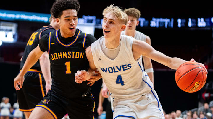 Northwest’s Colin Rice (4) drives to the basket against Johnston's Nicare Cavil (1) on March 10, 2026, at Casey’s Center in Des Moines.