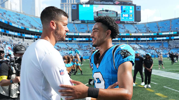 Sep 21, 2025; Charlotte, North Carolina, USA; Carolina Panthers head coach Dave Canalas with quarterback Bryce Young (9) after the game at Bank of America Stadium. Mandatory Credit: Bob Donnan-Imagn Images