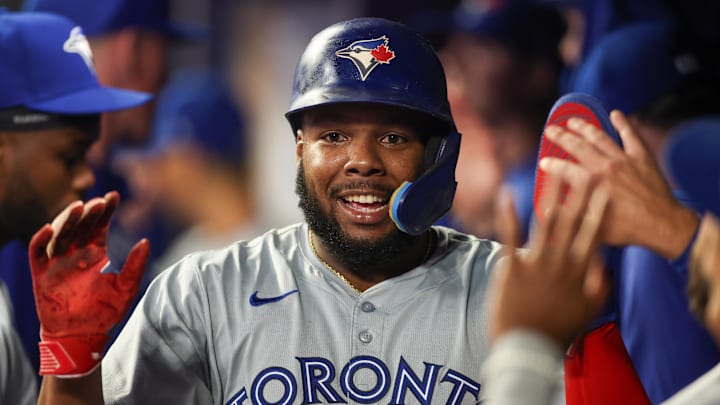 Sep 7, 2024; Atlanta, Georgia, USA; Toronto Blue Jays designated hitter Vladimir Guerrero Jr. (27) celebrates with teammates after scoring a run against the Atlanta Braves in the ninth inning at Truist Park. Mandatory Credit: Brett Davis-Imagn Images Sep 7, 2024; Atlanta, Georgia, USA; Toronto Blue Jays designated hitter Vladimir Guerrero Jr. (27) celebrates with teammates after scoring a run against the Atlanta Braves in the ninth inning at Truist Park. Mandatory Credit: Brett Davis-Imagn Images