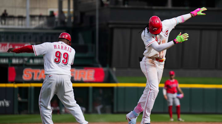 Apr 12, 2026; Cincinnati, Ohio, USA;  Cincinnati Reds shortstop Elly de la Cruz, right, gestures with third base coach Willie Harris (99), after hitting a three-run home run against the Los Angeles Angels in the ninth inning at Great American Ball Park. Mandatory Credit: Aaron Doster-Imagn Images