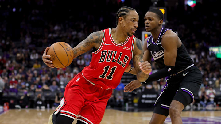 Mar 14, 2022; Sacramento, California, USA; Chicago Bulls forward DeMar DeRozan (11) dribbles the ball around Sacramento Kings guard De'Aaron Fox (5) during the third quarter at Golden 1 Center. Mandatory Credit: Sergio Estrada-Imagn Images