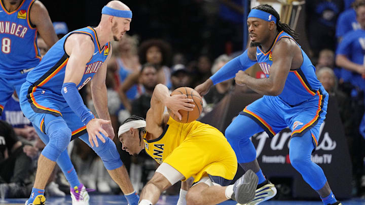 Jun 8, 2025; Oklahoma City, Oklahoma, USA; Indiana Pacers guard Andrew Nembhard (2) falls with the ball against Oklahoma City Thunder guard Alex Caruso (left) and guard Luguentz Dort (right) during the second half during game two of the 2025 NBA Finals at Paycom Center. Mandatory Credit: Kyle Terada-Imagn Images Jun 8, 2025; Oklahoma City, Oklahoma, USA; Indiana Pacers guard Andrew Nembhard (2) falls with the ball against Oklahoma City Thunder guard Alex Caruso (left) and guard Luguentz Dort (right) during the second half during game two of the 2025 NBA Finals at Paycom Center. Mandatory Credit: Kyle Terada-Imagn Images