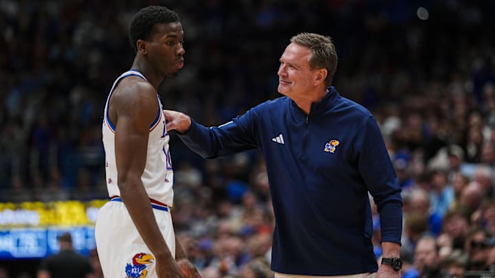 Jan 13, 2026; Lawrence, Kansas, USA; Kansas Jayhawks head coach Bill Self talks with guard Melvin Council Jr. (14) during the second half against the Iowa State Cyclones at Allen Fieldhouse. Mandatory Credit: Jay Biggerstaff-Imagn Images