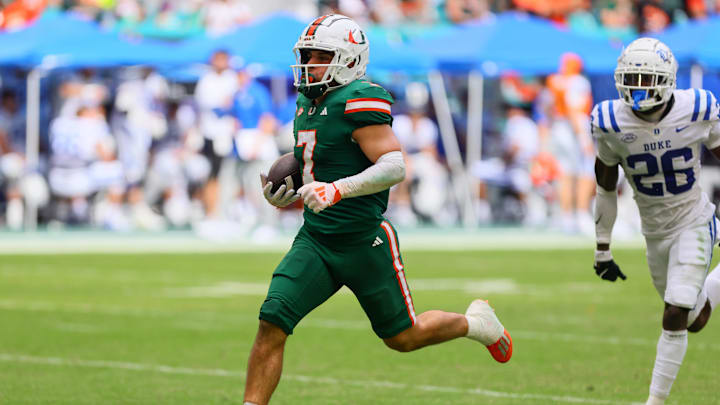 Nov 2, 2024; Miami Gardens, Florida, USA; Miami Hurricanes wide receiver Xavier Restrepo (7) runs with the football for a touchdown against the Duke Blue Devils during the fourth quarter at Hard Rock Stadium. Mandatory Credit: Sam Navarro-Imagn Images Nov 2, 2024; Miami Gardens, Florida, USA; Miami Hurricanes wide receiver Xavier Restrepo (7) runs with the football for a touchdown against the Duke Blue Devils during the fourth quarter at Hard Rock Stadium. Mandatory Credit: Sam Navarro-Imagn Images