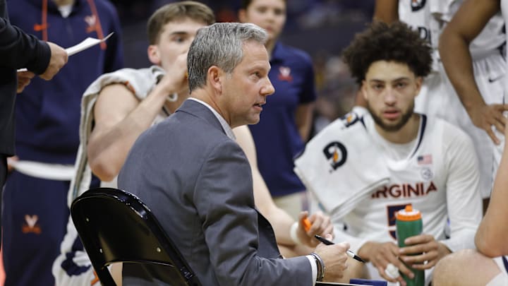 Jan 7, 2026; Charlottesville, Virginia, USA; Virginia Cavaliers head coach Ryan Odom (center) huddles with players on the court during a stoppage in play against the California Golden Bears during the first half at John Paul Jones Arena. Mandatory Credit: Amber Searls-Imagn Images