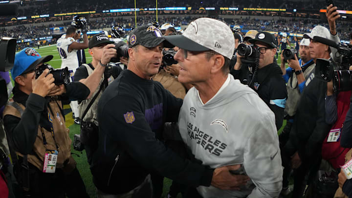 Baltimore Ravens coach John Harbaugh hugs his brother, Los Angeles Chargers coach Jim Harbaugh, after a victory Monday night.