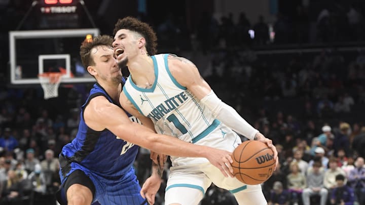 Nov 25, 2024; Charlotte, North Carolina, USA;  Orlando Magic forward Franz Wagner (22) tries to strip the ball from Charlotte Hornets guard LaMelo ball (1) during the second half at the Spectrum Center. Mandatory Credit: Sam Sharpe-Imagn Images